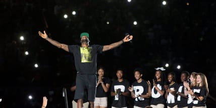 LeBron James acknowledges the crowd's reaction as he takes the stage for the I PROMISE Family Reunion event to welcome him home