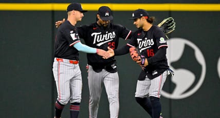 Byron Buxton embraces Minnesota Twins teammates in the outfield after win vs the Texas Rangers