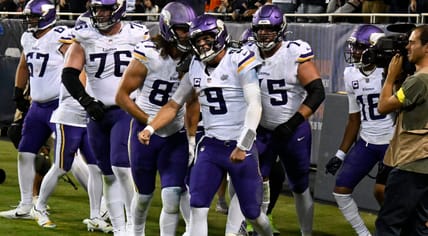 JJ McCarthy celebrates with teammates after scoring a rushing touchdown - Minnesota Vikings at Chicago Bears