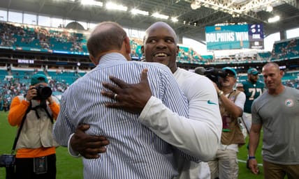 Minnesota Vikings defensive coordinator Brian Flores hugging Miami Dolphins owner Stephen Ross in 2022
