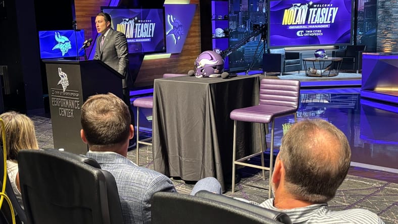 Rob Brzezinski and Kevin O'Connell watch on as Nolan Teasley is introduced at TCO Performance Center as Minnesota Vikings general manager