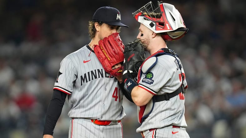 Minnesota Twins pitcher Joe Ryan (41) and Minnesota Twins catcher Ryan Jeffers (27) talk at the mound during a game against the