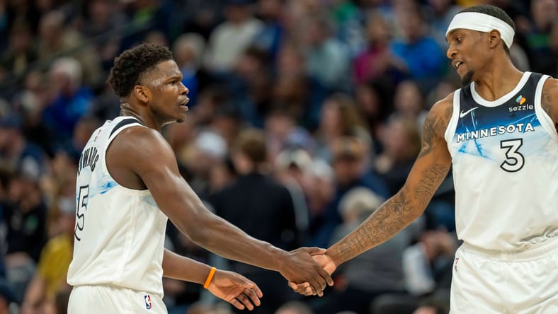 Mar 9, 2025; Minneapolis, Minnesota, USA; Minnesota Timberwolves guard Anthony Edwards (5) shakes hands with forward Jaden McDaniels (3) after making a shot against the San Antonio Spurs in the first half at Target Center. Mandatory Credit: Jesse Johnson-Imagn Images