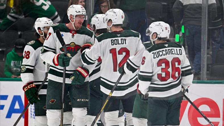 Mats Zuccarello, Matt Boldy and Michael McCarron dap up during Stanley Cup Playoffs - Minnesota Wild at Dallas Stars