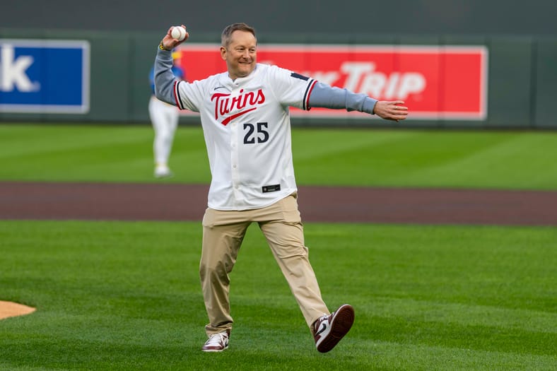 Minnesota Gophers men's basketball coach Niko Medved throws out the first pitch at a Minnesota Twins game