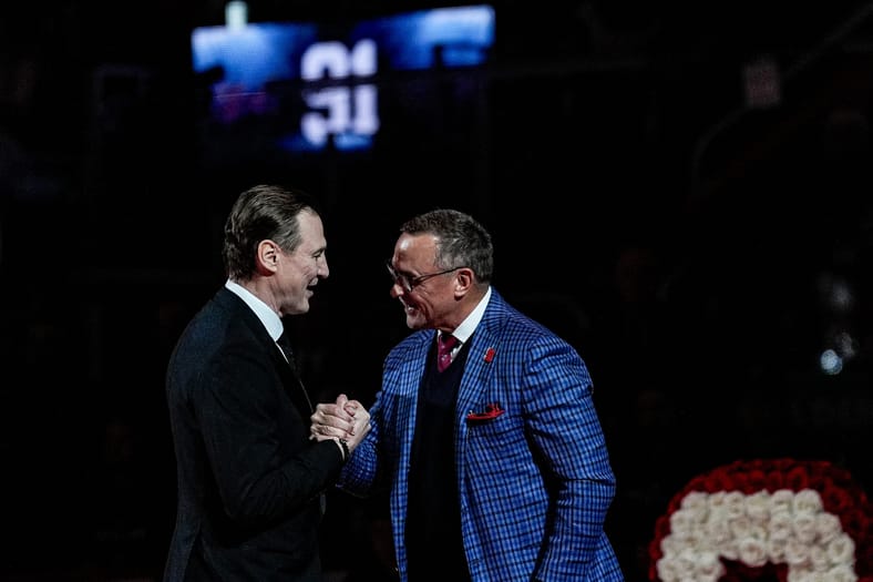 Sergei Fedorov shakes hands with Steve Yzerman during his jersey retirement ceremony at Little Caesars Arena in Detroit on
