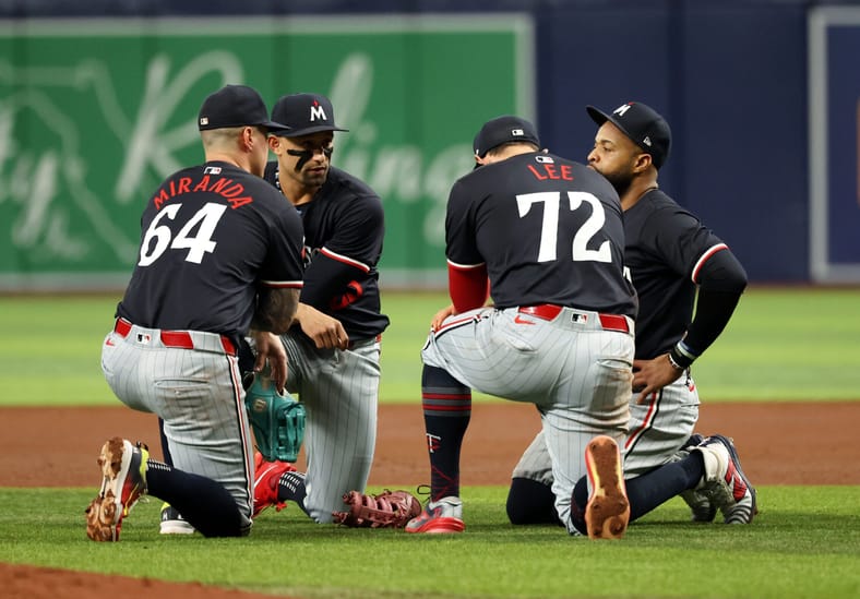 Brooks Lee and other infielders taking a knee in the infield - Minnesota Twins at Tampa Bay Rays