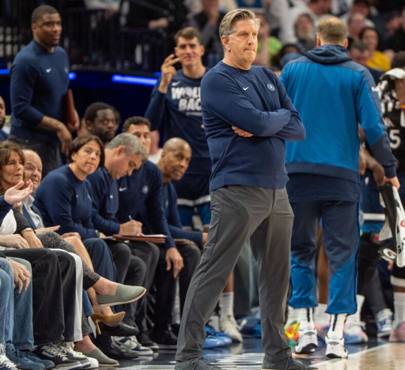 Minnesota Timberwolves head coach Chris Finch with Micah Nori sitting behind him